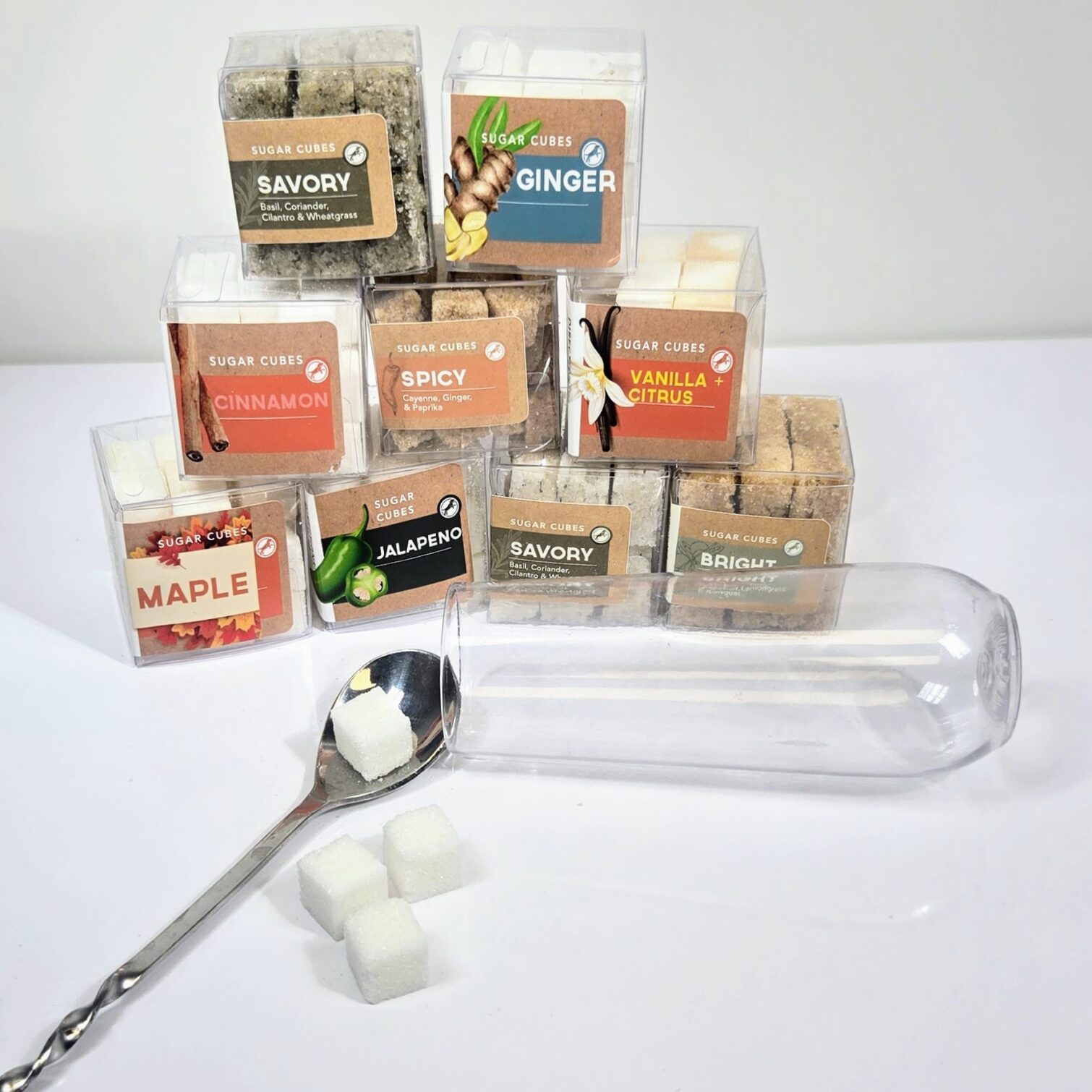 9 cube shaped boxes of custom blended unique fall flavors of sugar cubes. Ginger, Jalapeno, Vanilla+Citrus, Cinnamon, Maple, Spicy, and "Bright".
